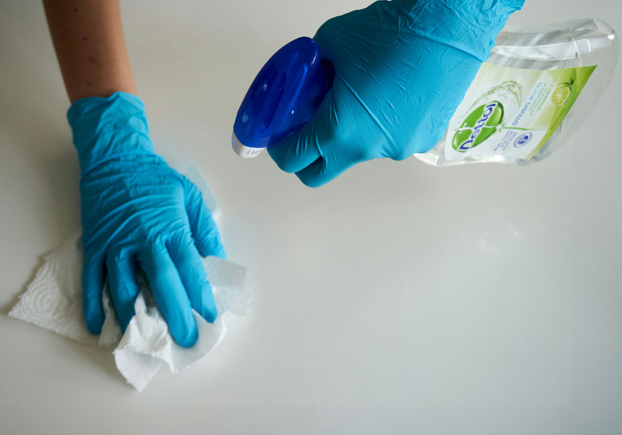 Professional cleaner cleaning with Dettol